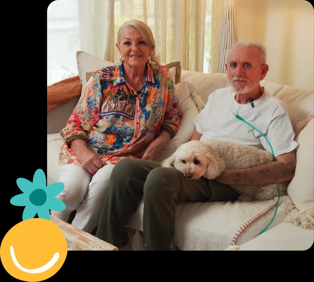 Older couple with a dog on a couch