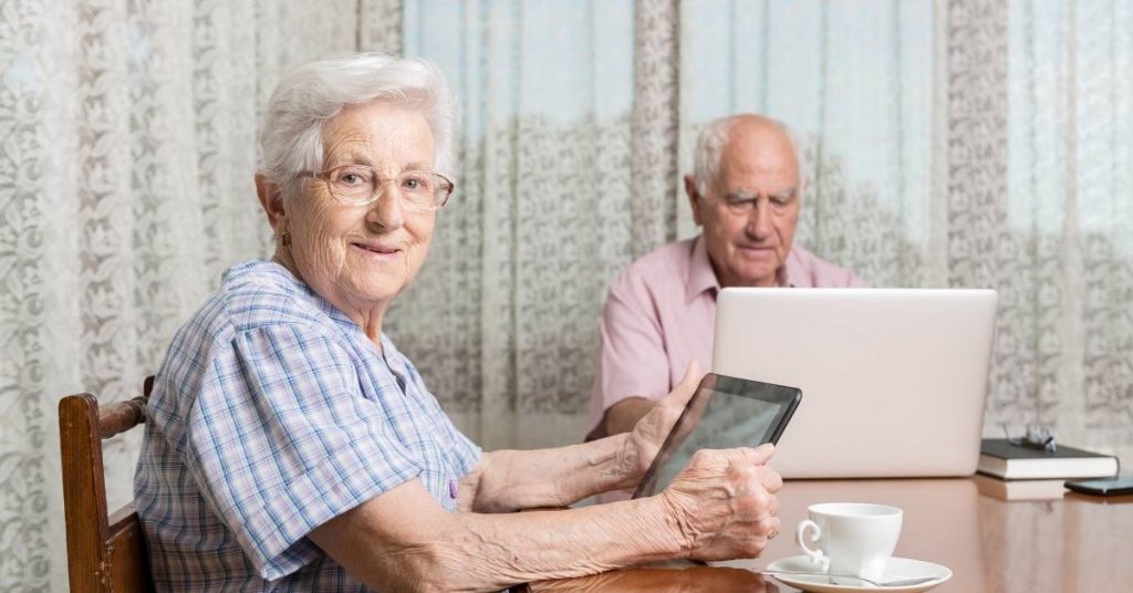 elderly couple browsing internet for home care package providers