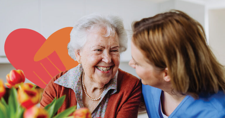 Joyful elderly lady laughing with a younger woman, abstract heart shapes in the foreground.