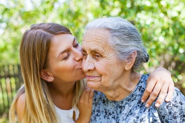 carer being compassionate with elderly woman
